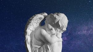 Statue of angelic cherub with decorative starry background