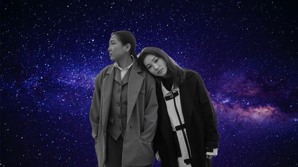 one woman with head on another woman's shoulder against starry sky