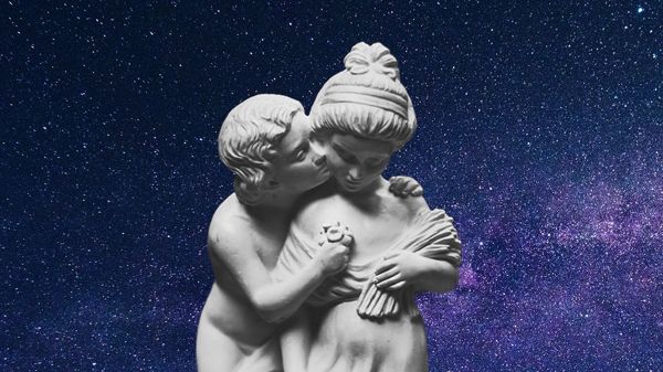 Statue of a couple with male showing affection to a possible reluctant female with a decorative starry background