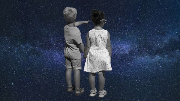 two kids looking out into decorative background of starry sky